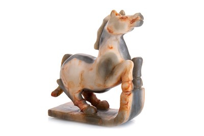 Lot 1199 - CHINESE RUSSET AND GREY JADE HORSE