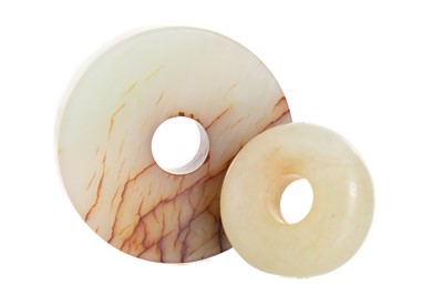 Lot 1203 - CHINESE CELADON AND RUSSET JADE BI DISC