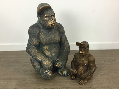 Lot 432 - GRADUATED PAIR OF GILT RESIN MODELS OF GORILLAS