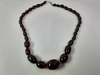 Lot 61 - STRING OF CHERRY AMBER-TYPE OVAL BEADS
