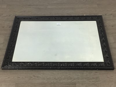 Lot 304 - WALL MIRROR IN A CARVED OAK FRAME