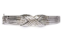 Lot 17 - DIAMOND SET BANGLE of crossover form, with...