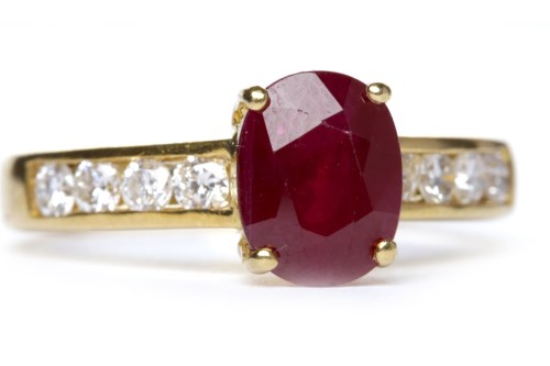 Lot 29 - RUBY AND DIAMOND RING set with an oval cut...