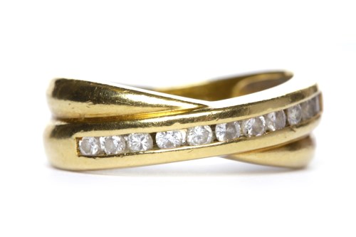 Lot 40 - DIAMOND SET BAND of crossover form and with a...