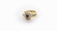 Lot 125 - SAPPHIRE DIAMOND CLUSTER RING the central oval...