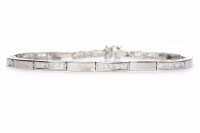 Lot 138 - DIAMOND BRACELET formed by sections of white...