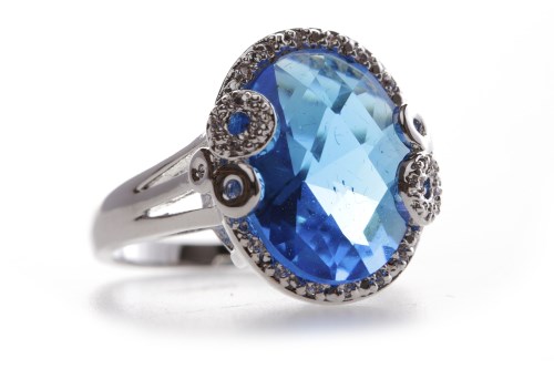 Lot 304 - BLUE AND WHITE GEM SET DRESS RING with an oval...
