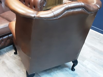 Lot 611 - DARK TAN LEATHER  WINGBACK ARMCHAIR