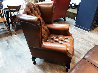 Lot 611 - DARK TAN LEATHER  WINGBACK ARMCHAIR