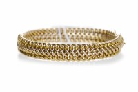 Lot 482 - YELLOW GOLD BANGLE of woven form, the metal...