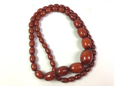Lot 112 - TWO SETS OF CHERRY COLOURED BEADS
