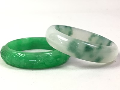 Lot 570 - TWO GREEN HARDSTONE BANGLES