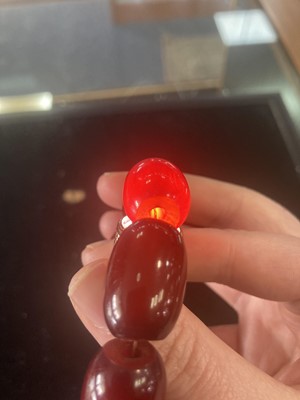 Lot 409 - EGG YOLK AMBER BEAD NECKLACE