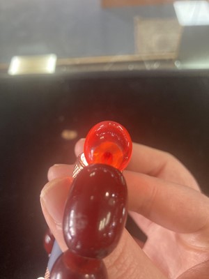 Lot 409 - EGG YOLK AMBER BEAD NECKLACE