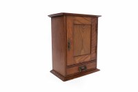 Lot 859 - 20TH CENTURY OAK TOBACCO CABINET the panelled...