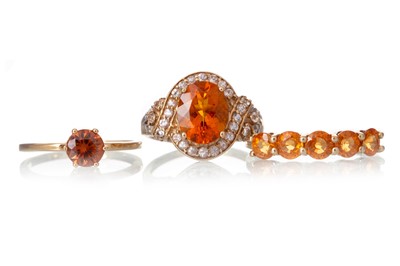 Lot 646 - THREE ORANGE GEM SET RINGS