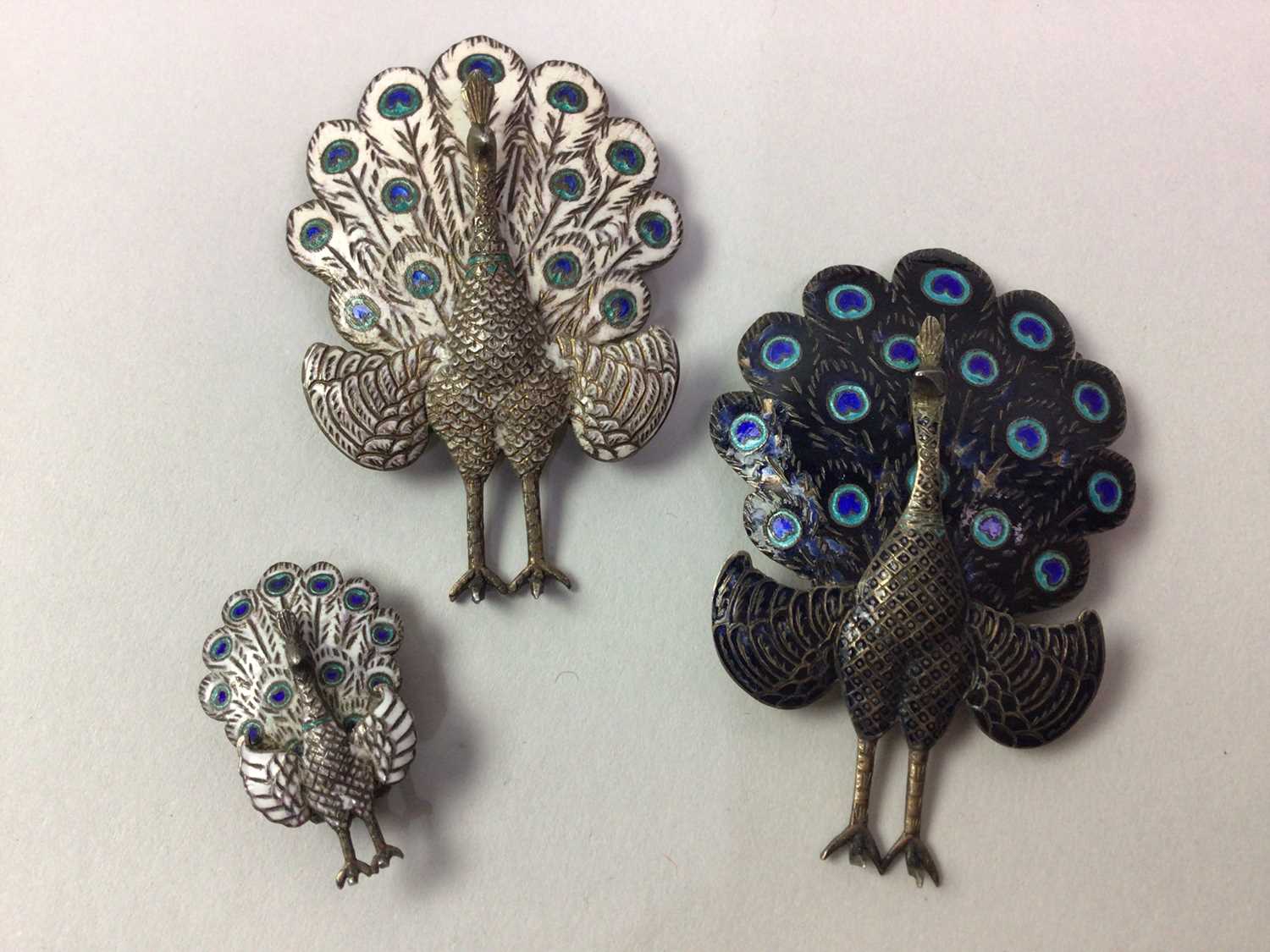 Lot 91 - TWO SIAM SILVER AND ENAMEL PEACOCK BROOCHES