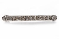 Lot 22 - DIAMOND BAR BROOCH set with a row of round...