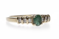 Lot 56 - EMERALD AND DIAMOND RING the central oval...