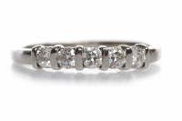Lot 249 - PLATINUM DIAMOND FIVE STONE RING with tension...