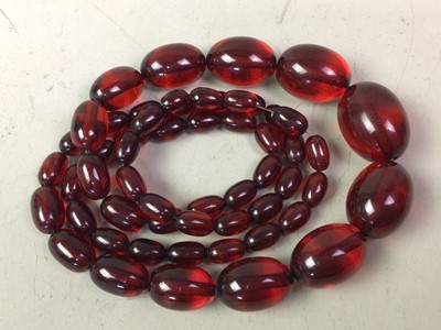 Lot 223 - TWO CHERRY COLOURED BEAD NECKLACES