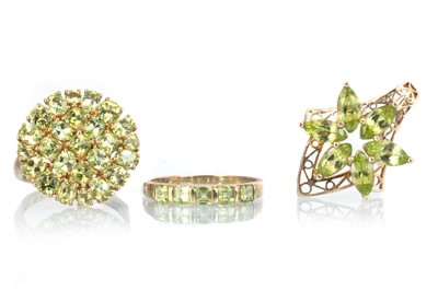 Lot 527 - TWO PERIDOT RINGS AND A PENDANT