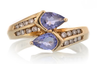 Lot 675 - TANZANITE AND DIAMOND RING