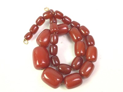 Lot 381 - SET OF GRADUATED CHERRY-AMBER-COLOURED BAKELITE BEADS