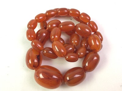 Lot 372 - SET OF GRADUATED AMBER-COLOURED BAKELITE-EFFECT BEADS