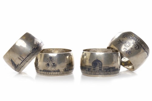 Lot 220 - FOUR NIELLO SILVER NAPKIN RINGS decorated with...