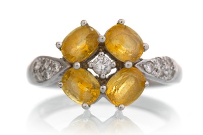 Lot 643 - YELLOW SAPPHIRE AND DIAMOND RING