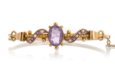 Lot 382 - EDWARDIAN AMETHYST AND SEED PEARL BANGLE