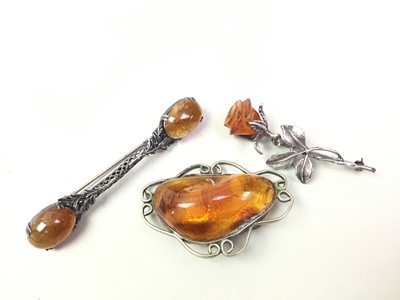 Lot 204 - THREE AMBER BROOCHES