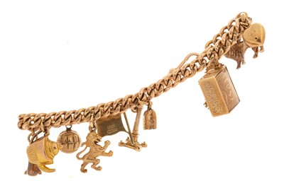 Lot 551 - NINE CARAT GOLD CHARM BRACELET.