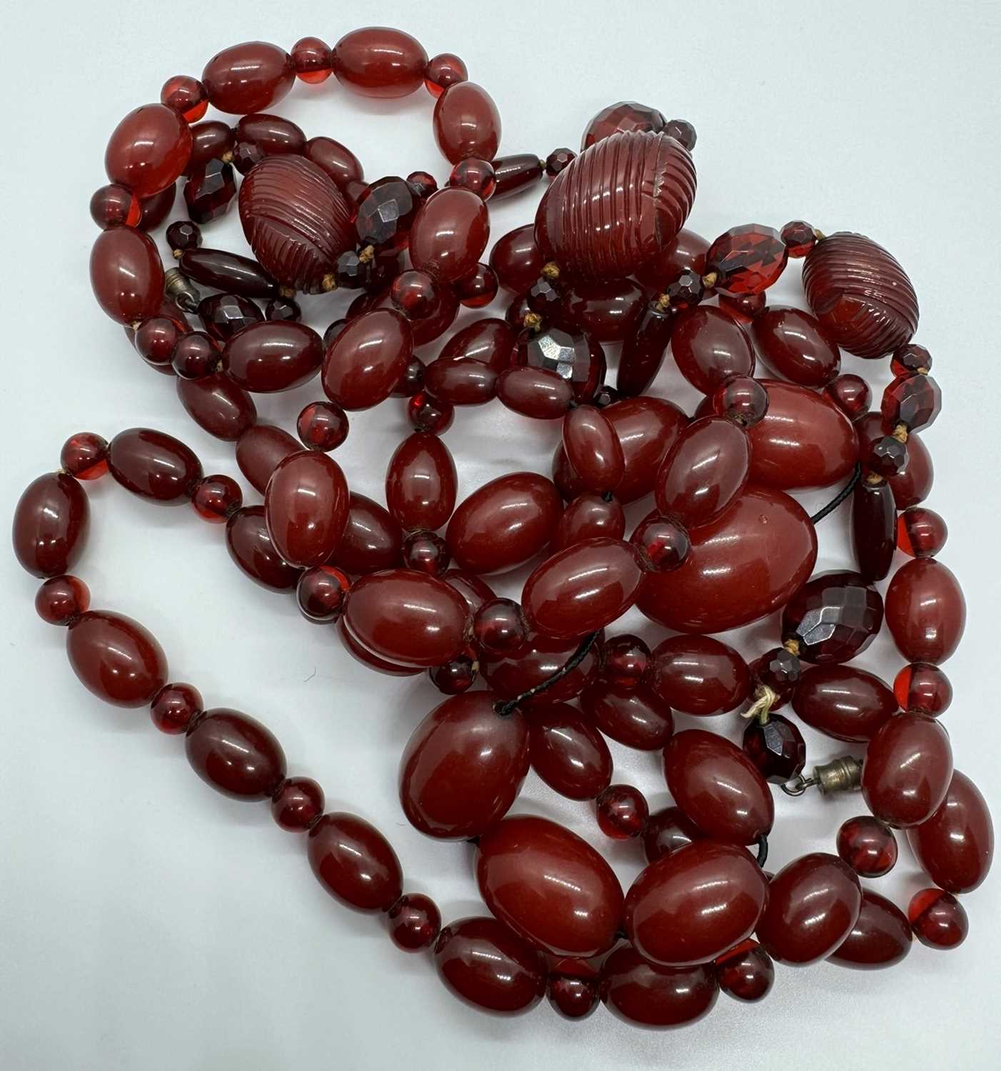 Lot 119 - THREE CHERRY AMBER BAKELITE BEAD NECKLACES
