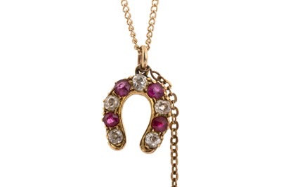 Lot 641 - RUBY AND DIAMOND HORSESHOE PENDANT