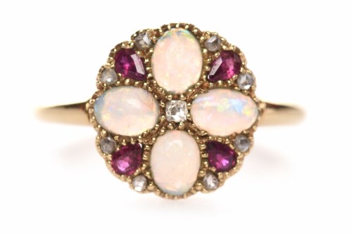 Lot 142 - RUBY AND OPAL DRESS RING the round bezel grain...