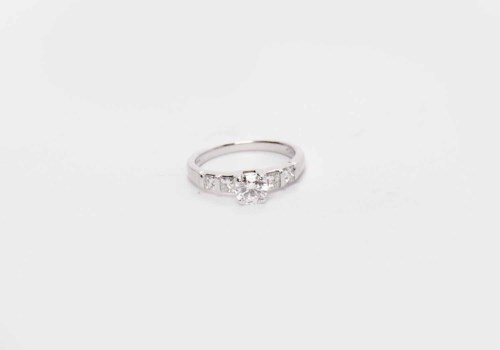 Lot 171 - DIAMOND SOLITAIRE RING with a four claw set...