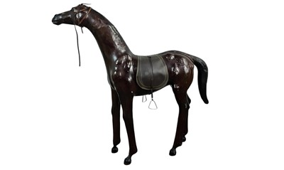 Lot 558 - IN THE MANNER OF LIBERTY & CO. OR ABERCROMBIE & FITCH, LEATHER COVERED HORSE.