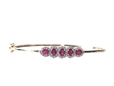 Lot 675 - RUBY AND ZIRCON BANGLE