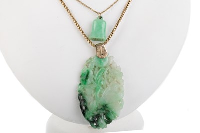Lot 597 - TWO JADE PENDANTS ON GOLD CHAINS