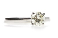 Lot 26 - PLATINUM DIAMOND SOLITAIRE RING with a four...