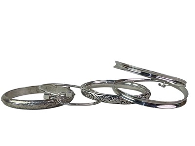 Lot 239 - FOUR SILVER BANGLES
