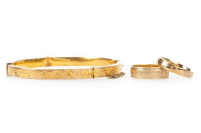 Lot 549 - GOLD BANGLE AND TWO WEDDING RINGS
