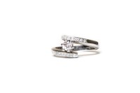Lot 111 - DIAMOND SOLITAIRE RING with a four claw set...
