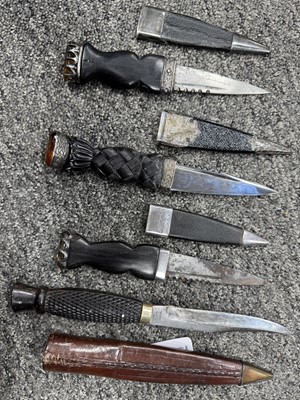 Lot 52 - THREE SILVER MOUNTED SGIAN DUBH