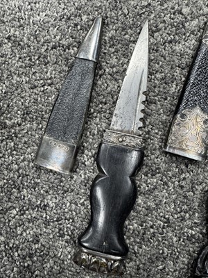 Lot 52 - THREE SILVER MOUNTED SGIAN DUBH