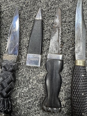 Lot 52 - THREE SILVER MOUNTED SGIAN DUBH