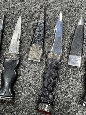 Lot 52 - THREE SILVER MOUNTED SGIAN DUBH