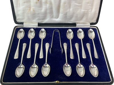 Lot 54 - SET OF TWELVE GEORGE V SILVER TEASPOONS AND SUGAR TONGS